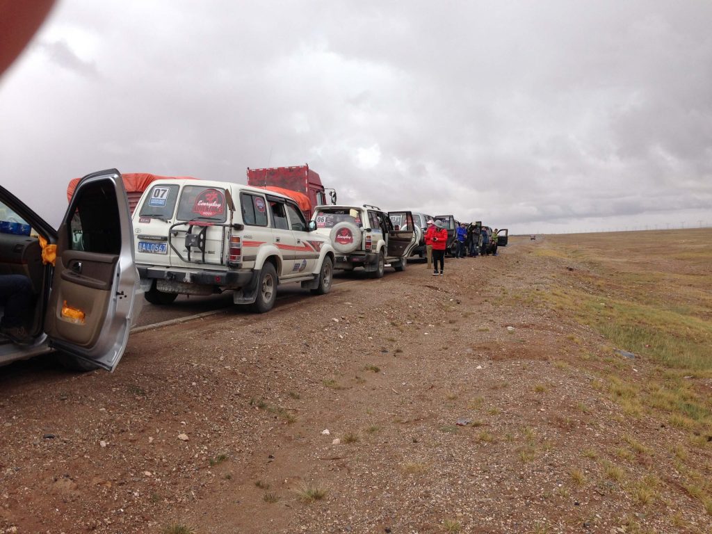 Row of Toyota Land Cruisers stopped for a rest on the journey to Tibet across central China.
