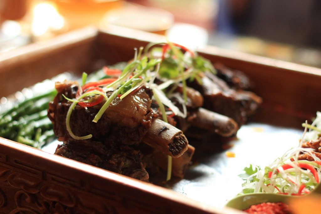 Things to do in Tibet: Eat yak meat dish with vegetables on Barkhor Street in Lhasa, Tibet.