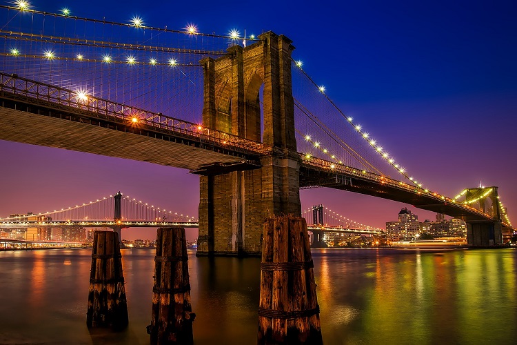 The Brooklyn Bridge lights up New York City
