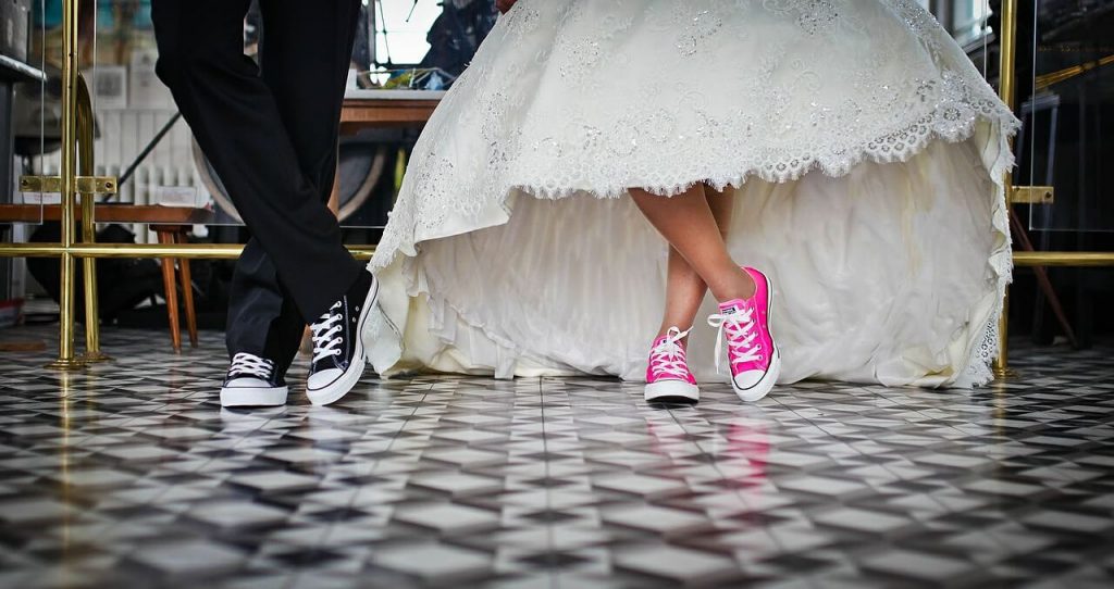a bride and groom in tennis shoes