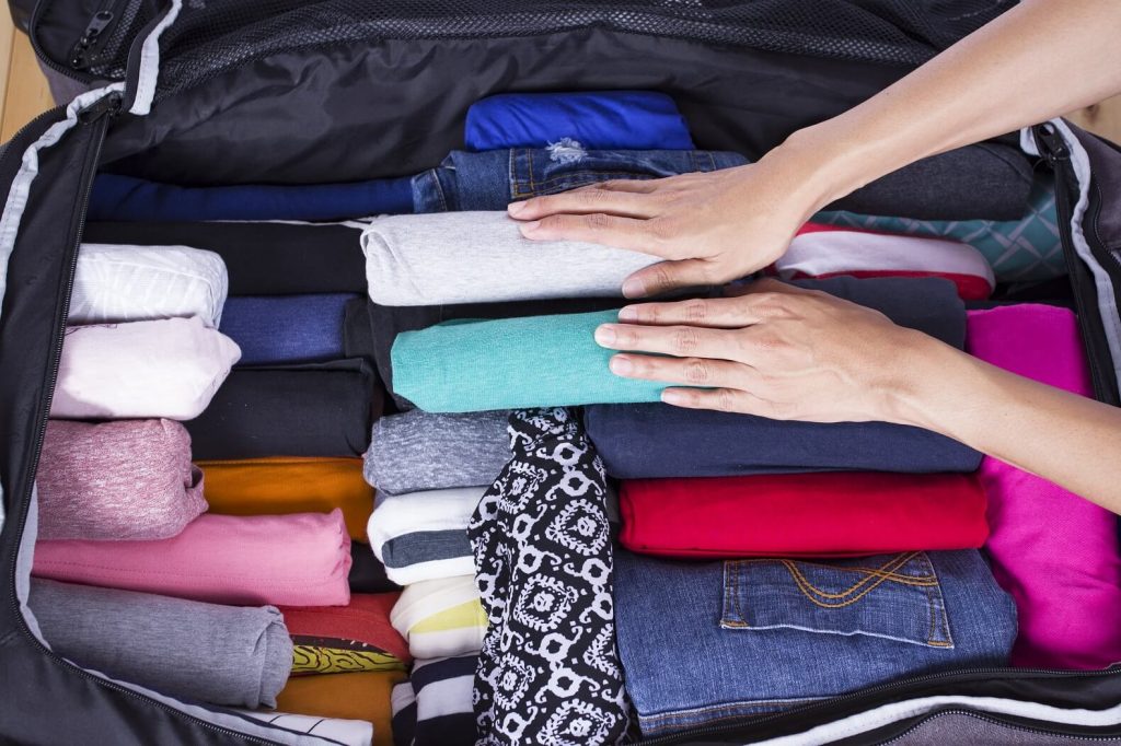 Packing light for one bag travel by rolling clothes