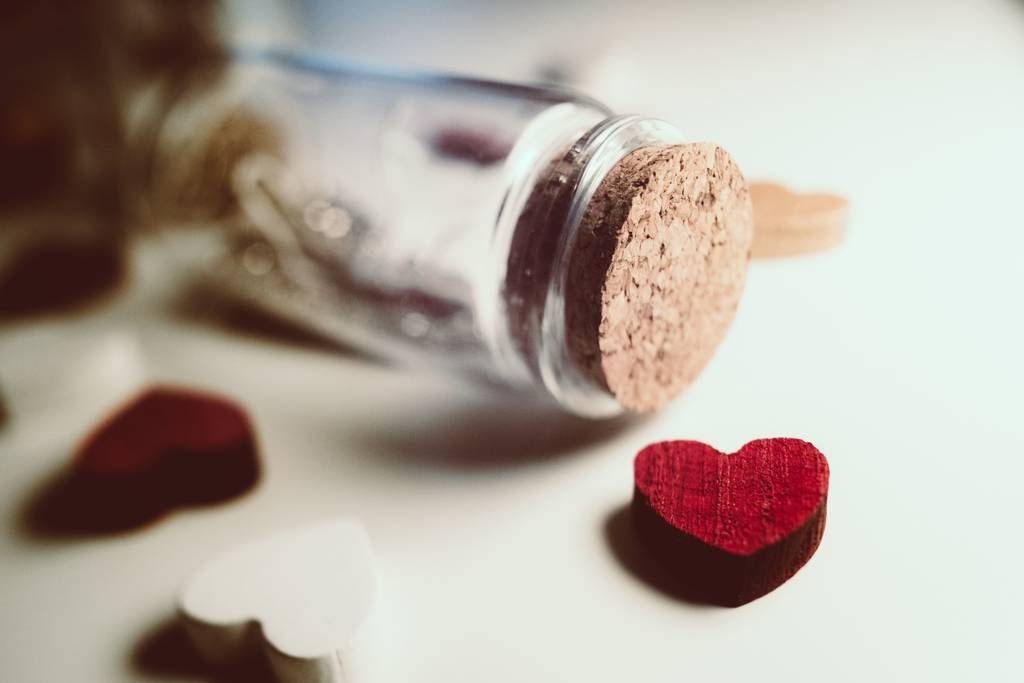 A glass jar and wooden heart