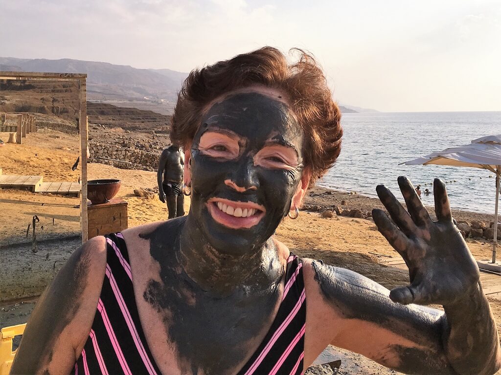 The Dead Sea one of the great Jordan attractions. Woman covered in mud