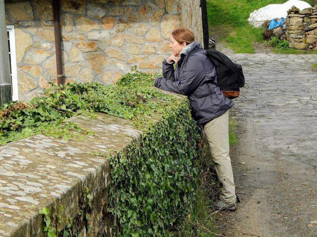 woman looking over bridge on the Camino de Santiago