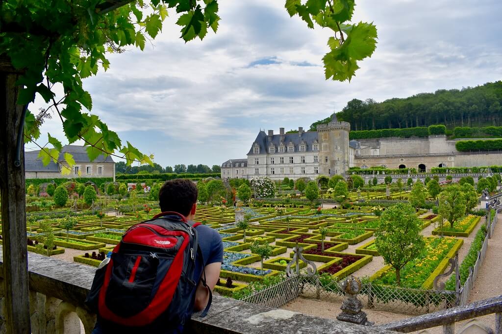 Nomadic Matt in front of French castle overcoming obstacles to travel