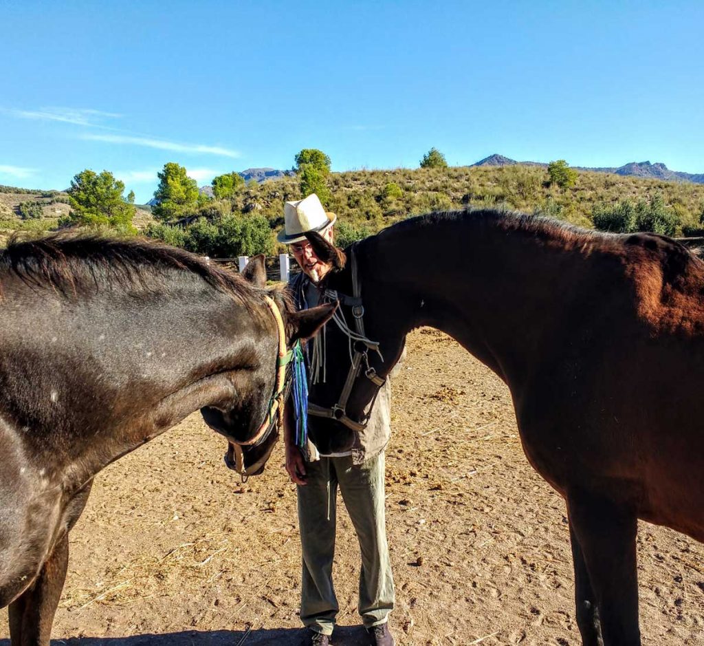 Man with horses while house sitting abroad