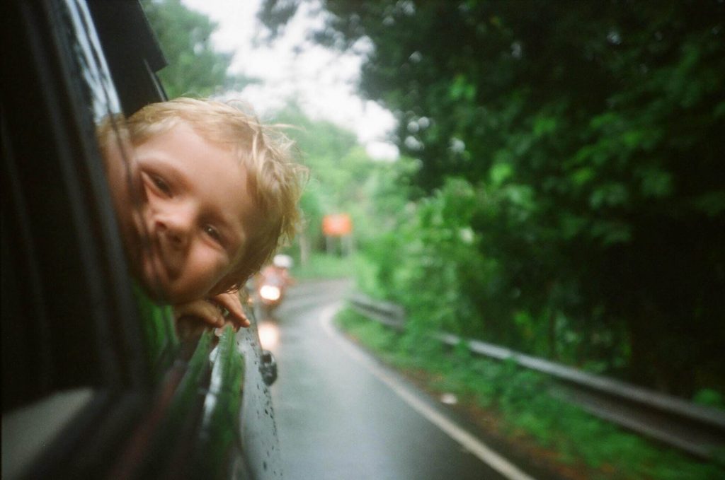 child looking out of a car