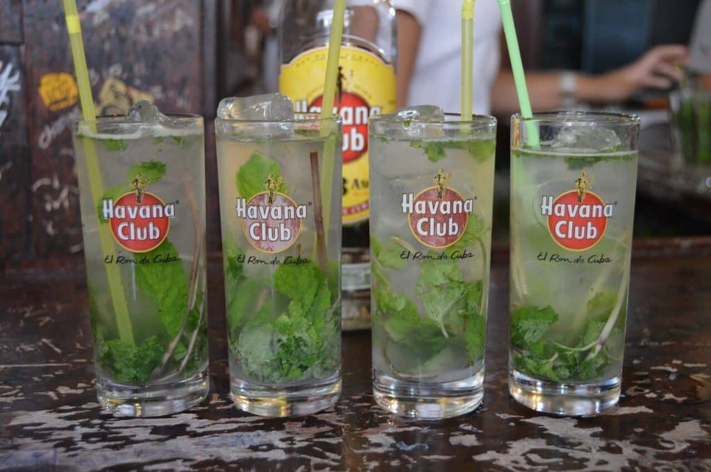 Four tall glasses of mojitos, a legendary cocktail form Cuba