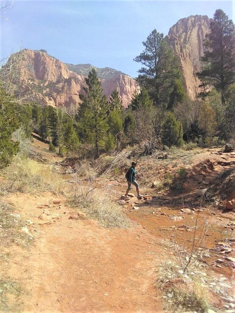 Woman crossing a creek in Utah