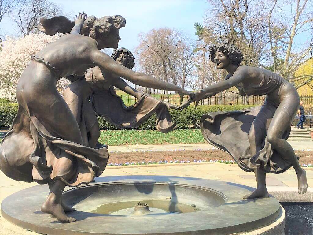 a sculpture of three women dancing in the Observatory Gardens in Museum Mile, one of the best places to sty in New York City 