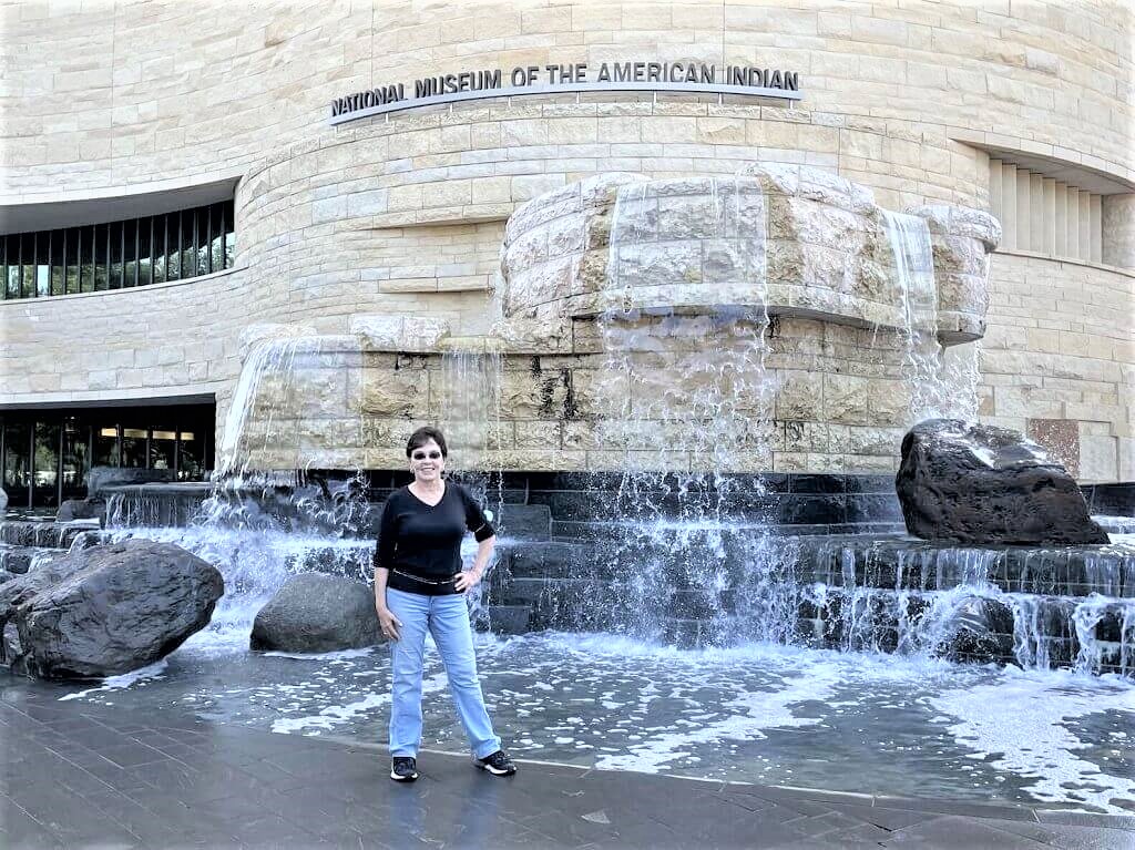 Woman in front of the National Museum of the American Indian