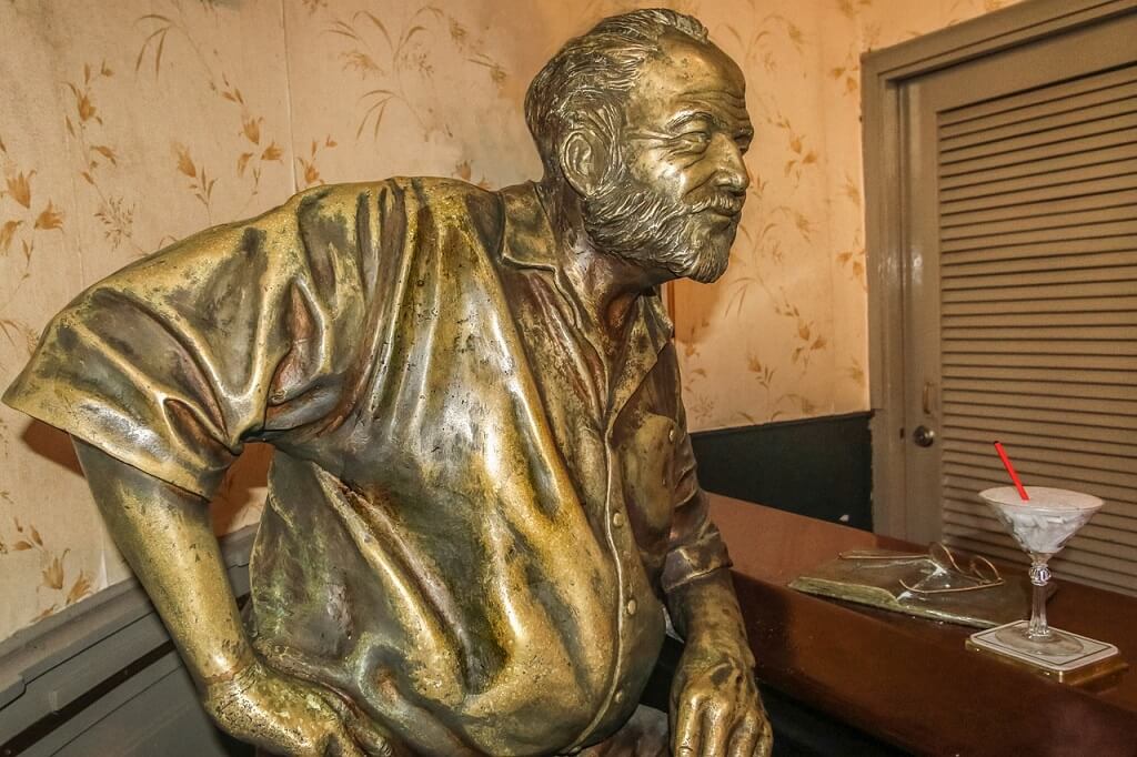 Ernest Hemingway's statue in El Floridita's bar where you'll find Cuba's typical food