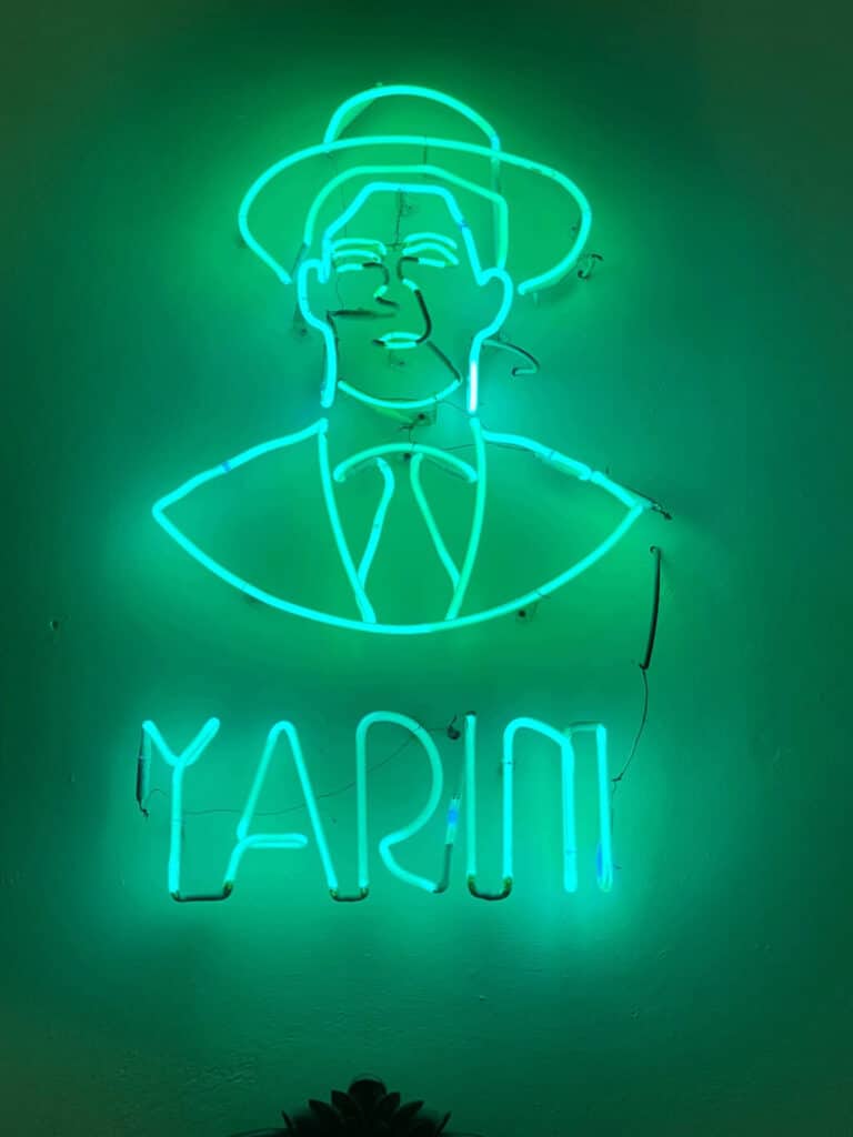 The Yarini sign in green neon
