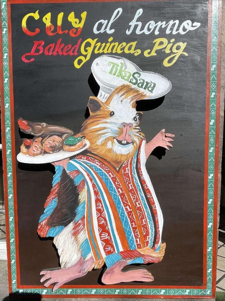 A sign advertising roasted guinea pig. This makes for a great meal in unique Peru