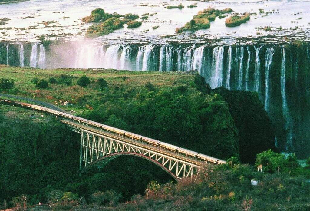 Luxury train journeys passing by Victoria Falls.