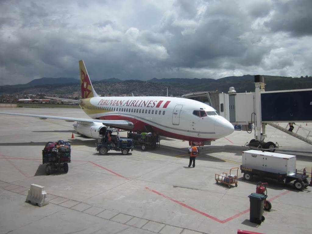 A Peruvian Airlines plane parked in the airport.