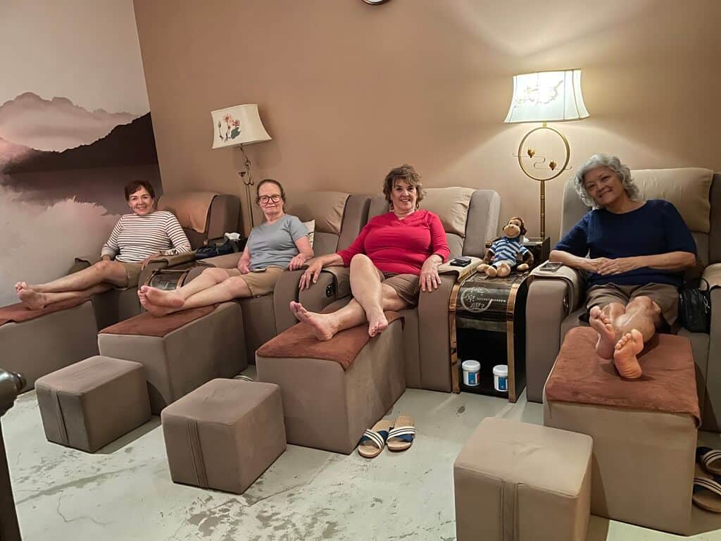 Women over 50 getting a foot massage
