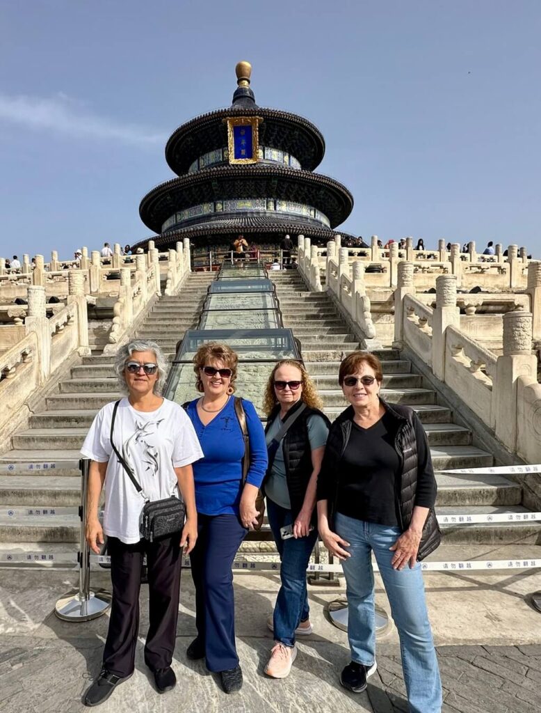 Four women over 50 travelers at the temple of heaven in Beijing.