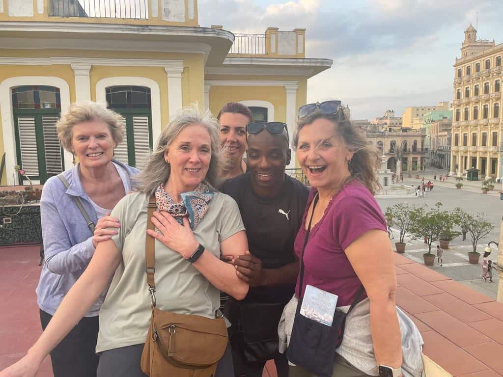Four women over 50 and one man laughing