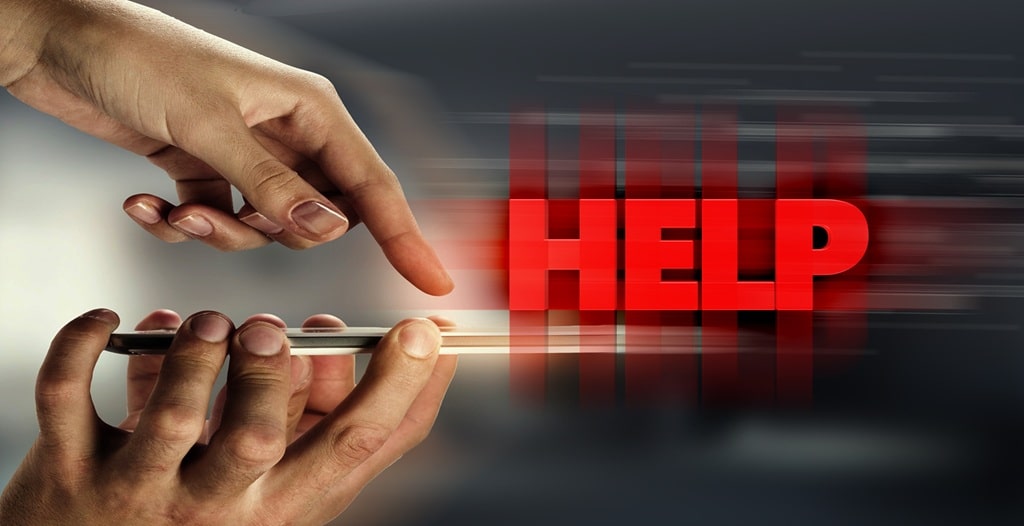 Two hands calling for help on a phone
