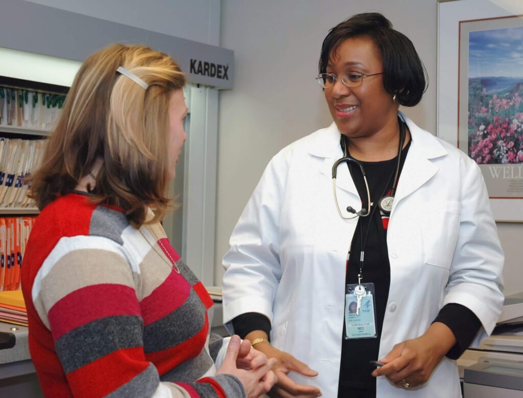 A doctor helping a woman stay healthy after 50