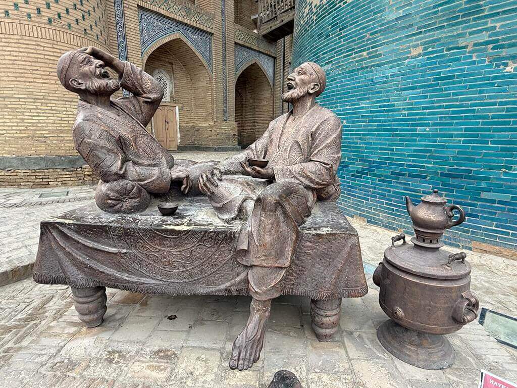 Statue of two men laughing in Khiva